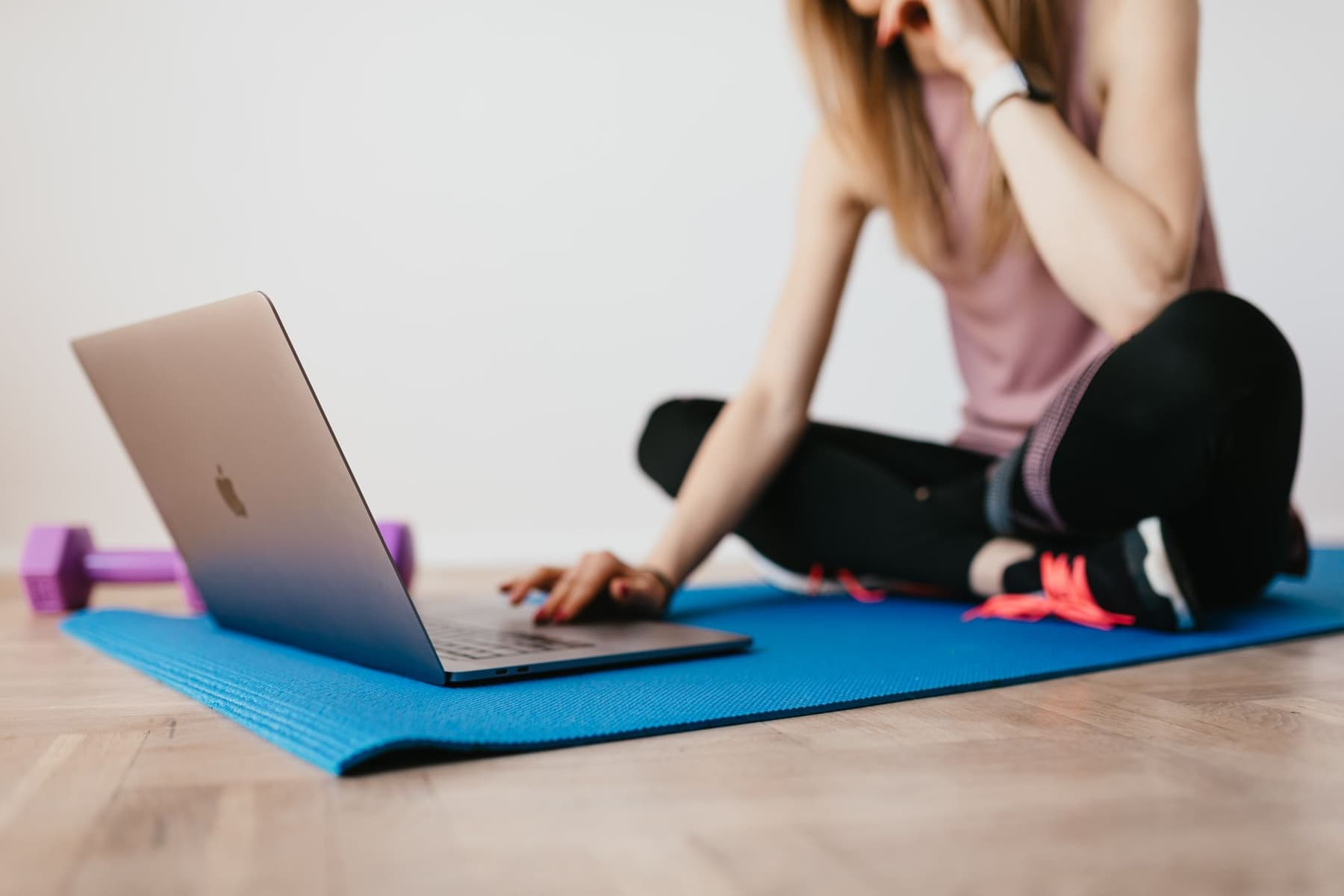 A laptop open on an exercise mat, ready for an online session